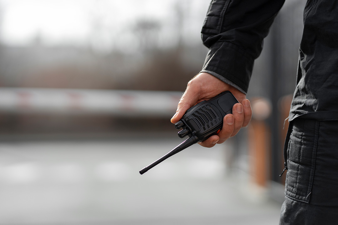 Close up of man holding handheld transceiver device